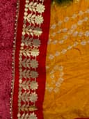 Woman wearing a orange embroidered kurti set by Nishtha Chadda