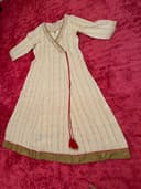 Woman wearing a maroon embroidered kurti set by Nishtha Chadda