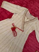 Woman wearing a maroon embroidered kurti set by Nishtha Chadda