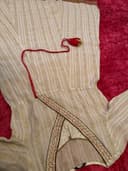 Woman wearing a maroon embroidered kurti set by Nishtha Chadda
