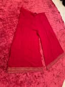 Woman wearing a maroon embroidered kurti set by Nishtha Chadda