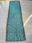 Woman wearing a teal embroidered kurti set by Nishtha Chadda