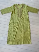 Woman wearing a olive embroidered kurti set by Nishtha Chadda