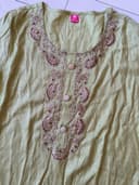 Woman wearing a olive embroidered kurti set by Nishtha Chadda