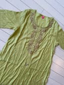 Woman wearing a olive embroidered kurti set by Nishtha Chadda