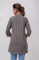 Woman wearing a grey indian kurti for women by Nishtha Chadda