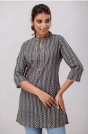 Woman wearing a grey indian kurti for women by Nishtha Chadda
