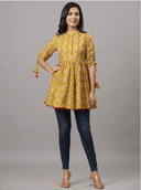 Woman wearing a mustard indian kurti for women by Nishtha Chadda