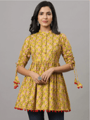 Woman wearing a mustard indian kurti for women by Nishtha Chadda