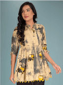 Woman wearing a coral indian kurti for women by Nishtha Chadda