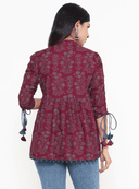 Woman wearing a maroon indian kurti for women by Nishtha Chadda