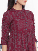 Woman wearing a maroon indian kurti for women by Nishtha Chadda