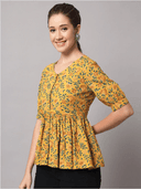 Woman wearing a mustard indian kurti for women by Nishtha Chadda