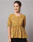 Woman wearing a mustard indian kurti for women by Nishtha Chadda