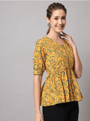Woman wearing a mustard indian kurti for women by Nishtha Chadda