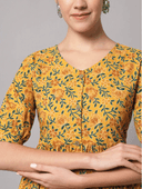 Woman wearing a mustard indian kurti for women by Nishtha Chadda