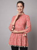 Woman wearing a coral indian kurti for women by Nishtha Chadda