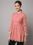 Woman wearing a coral indian kurti for women by Nishtha Chadda