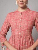 Woman wearing a coral indian kurti for women by Nishtha Chadda