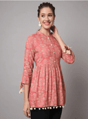 Woman wearing a coral indian kurti for women by Nishtha Chadda