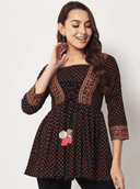 Woman wearing a brown indian kurti for women by Nishtha Chadda