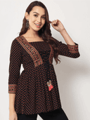 Woman wearing a brown indian kurti for women by Nishtha Chadda