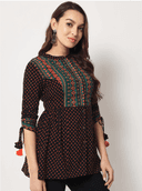 Woman wearing a brown indian kurti for women by Nishtha Chadda