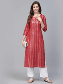 Woman wearing a red indian kurti for women by Nishtha Chadda