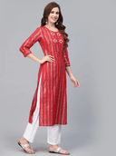 Woman wearing a red indian kurti for women by Nishtha Chadda