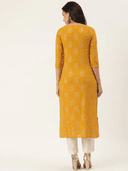 Woman wearing a mustard indian kurti for women by Nishtha Chadda