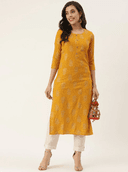 Woman wearing a mustard indian kurti for women by Nishtha Chadda
