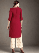 Woman wearing a red indian kurti for women by Nishtha Chadda