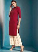 Woman wearing a red indian kurti for women by Nishtha Chadda