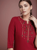 Woman wearing a red indian kurti for women by Nishtha Chadda