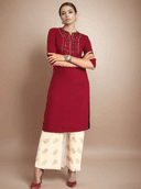 Woman wearing a red indian kurti for women by Nishtha Chadda