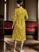 Woman wearing a mustard indian kurti for women by Nishtha Chadda