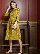 Woman wearing a mustard indian kurti for women by Nishtha Chadda