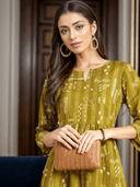 Woman wearing a mustard indian kurti for women by Nishtha Chadda