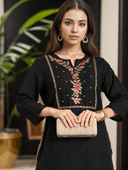 Woman wearing a maroon indian kurti for women by Nishtha Chadda
