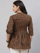 Woman wearing a brown indian kurti for women by Nishtha Chadda