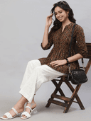 Woman wearing a brown indian kurti for women by Nishtha Chadda