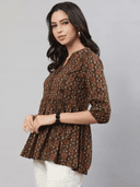 Woman wearing a brown indian kurti for women by Nishtha Chadda
