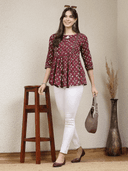 Woman wearing a brown indian kurti for women by Nishtha Chadda
