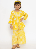 Woman wearing a yellow indian kurti for women by Nishtha Chadda