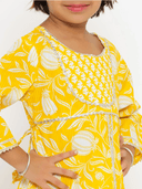 Woman wearing a yellow indian kurti for women by Nishtha Chadda