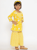 Woman wearing a yellow indian kurti for women by Nishtha Chadda