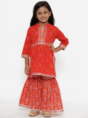 Woman wearing a red indian kurti for women by Nishtha Chadda