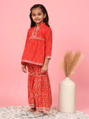 Woman wearing a red indian kurti for women by Nishtha Chadda