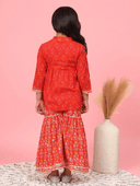 Woman wearing a red indian kurti for women by Nishtha Chadda