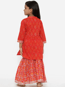 Woman wearing a red indian kurti for women by Nishtha Chadda